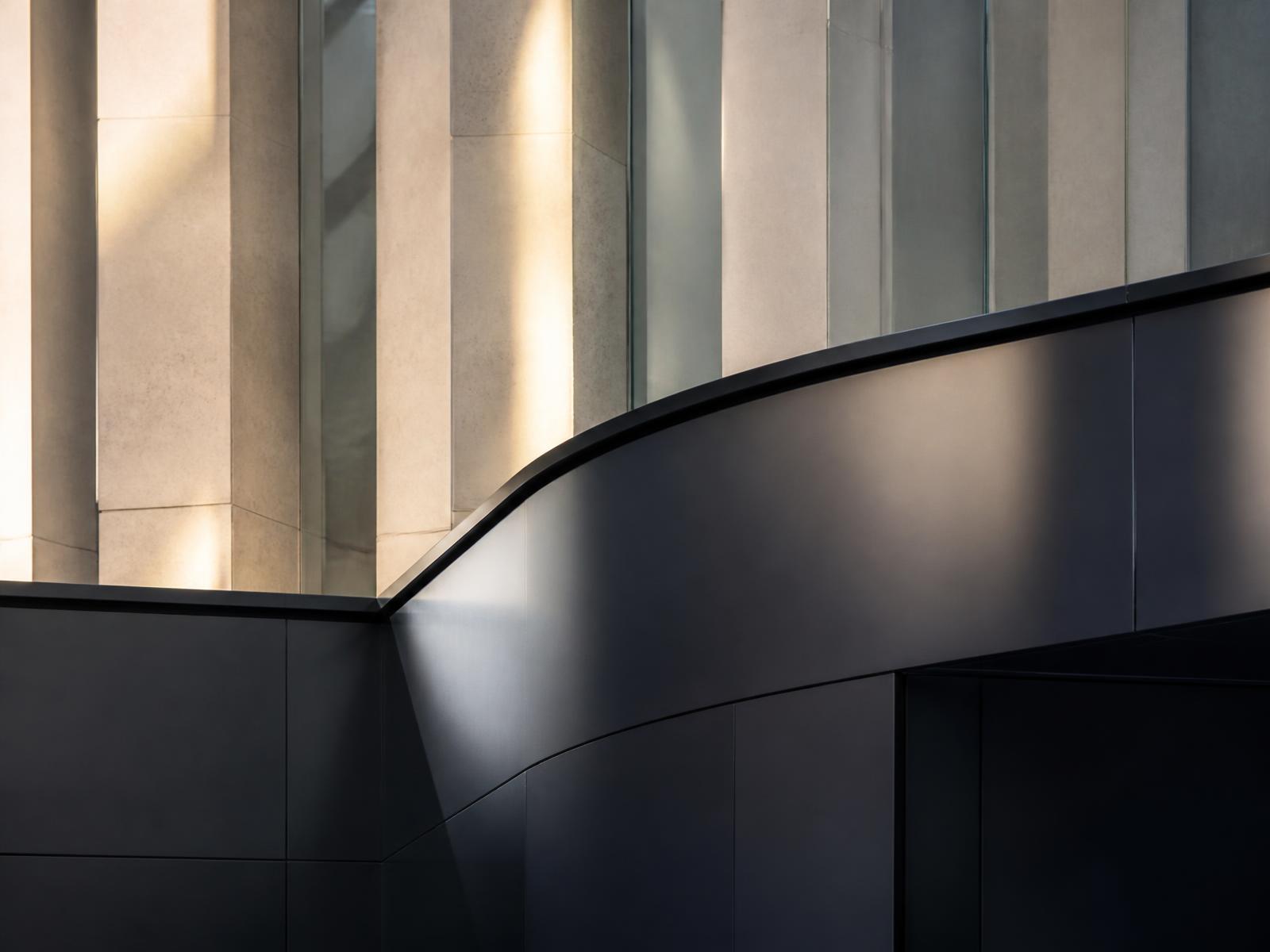 Contemporary hospital atrium architecture in limestone and navy